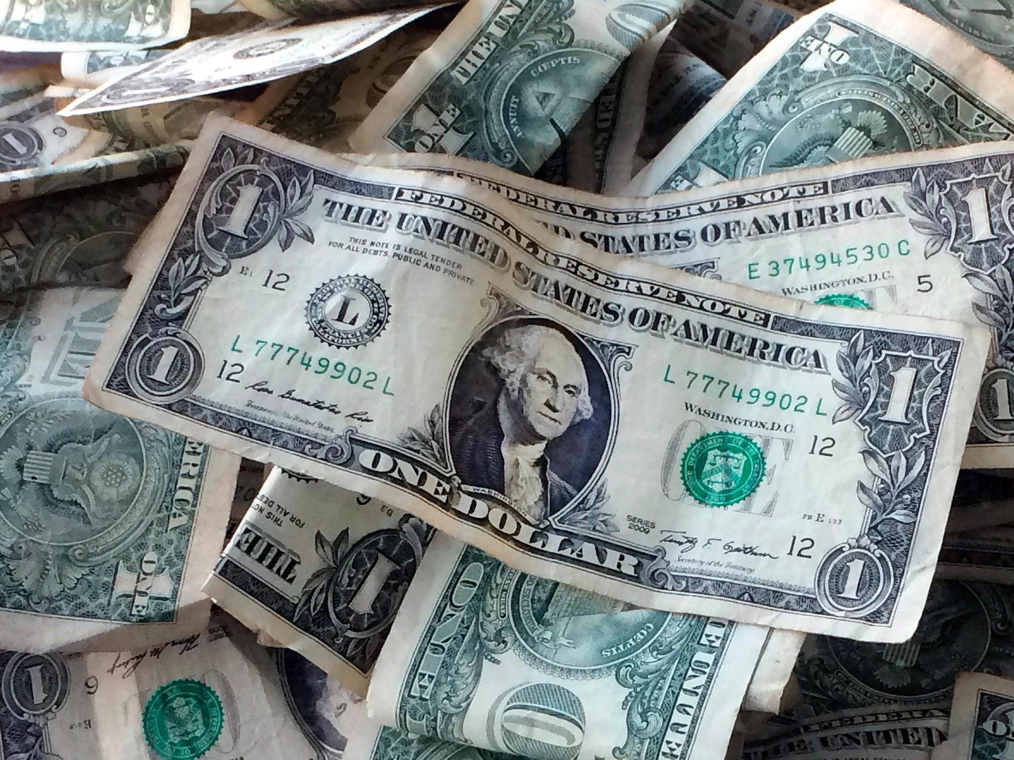 FILE – This Oct. 24, 2016 file photo shows dollar bills in New York. (AP Photo/Mark Lennihan, File)
