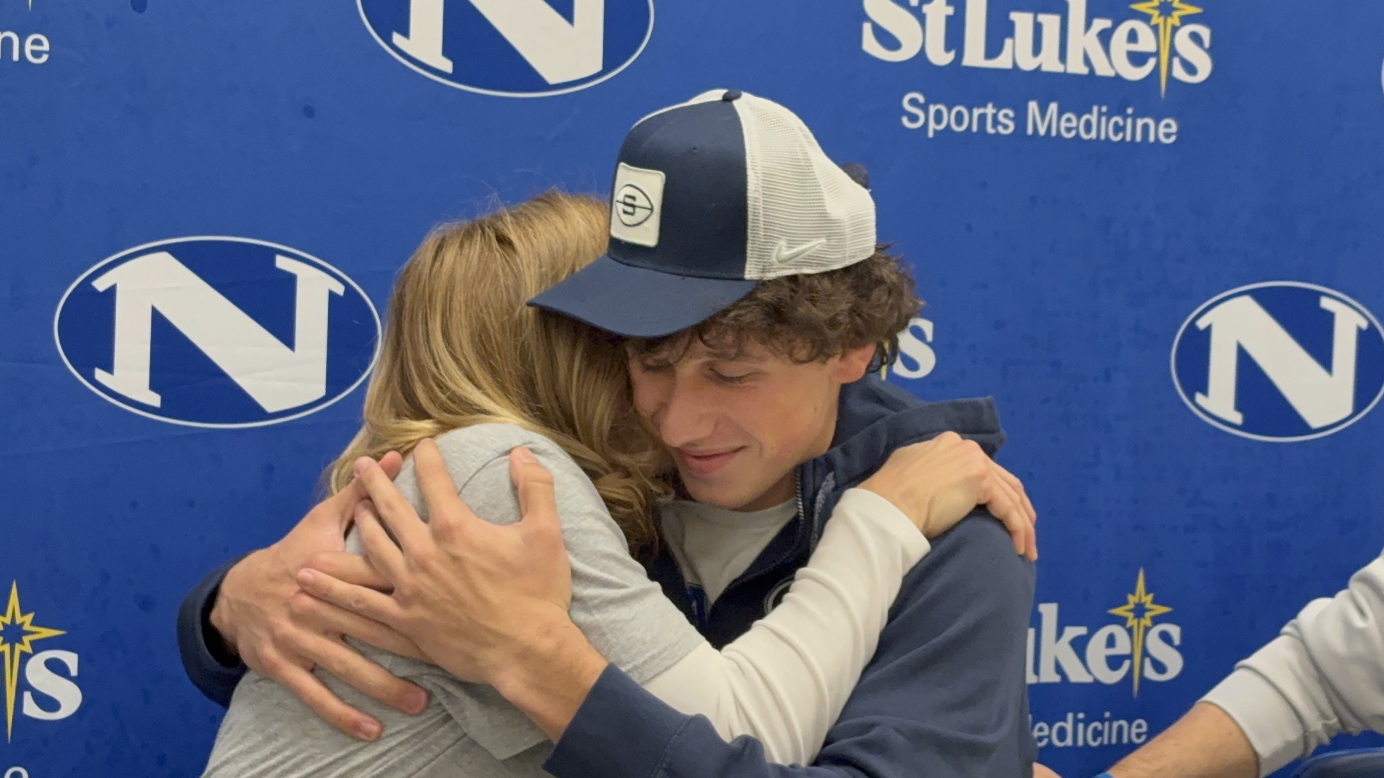 Nazareth standout quarterback Peyton Falzone hugs his mom, Stephanie, after announcing that he will attend Penn State on Wednesday, December 3, 2025, at Nazareth High School. (Keith Groller/The Morning Call)
