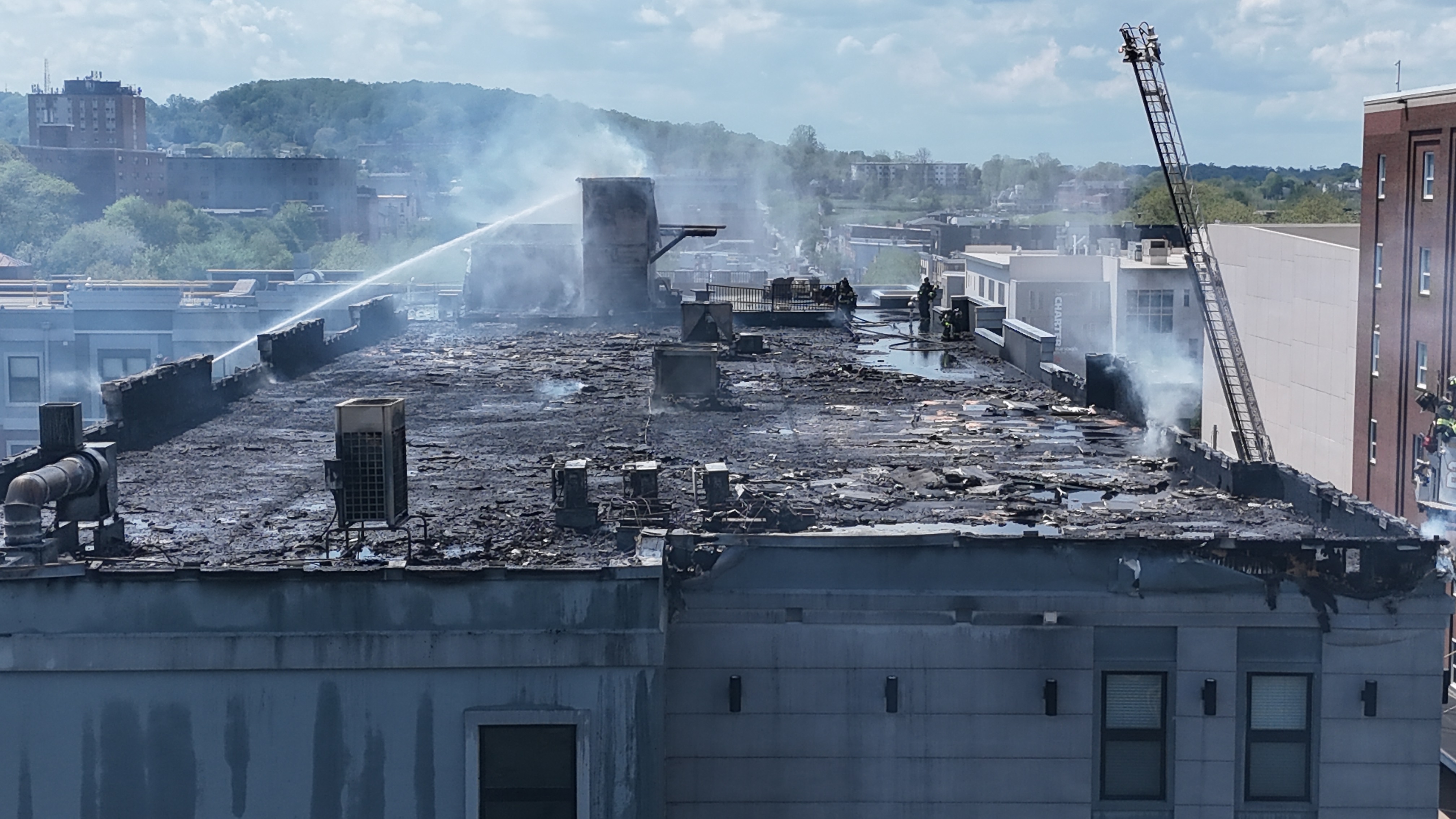 The roof of the Five 10 Flats apartment complex at 510 E. Third St. in south Bethlehem is heavily damaged by fire Friday, May 2, 2025. (Rich Rolen/Special to The Morning Call)
